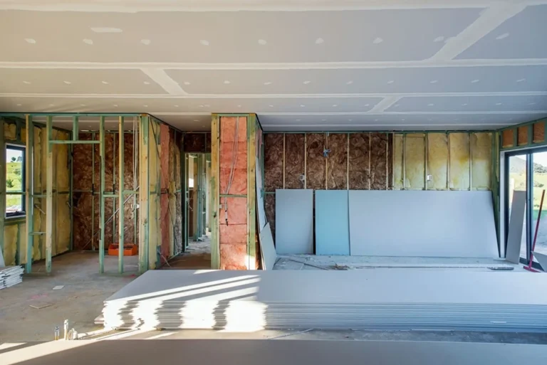 New home interior with plasterboard ceiling installed and walls framed with insulation.