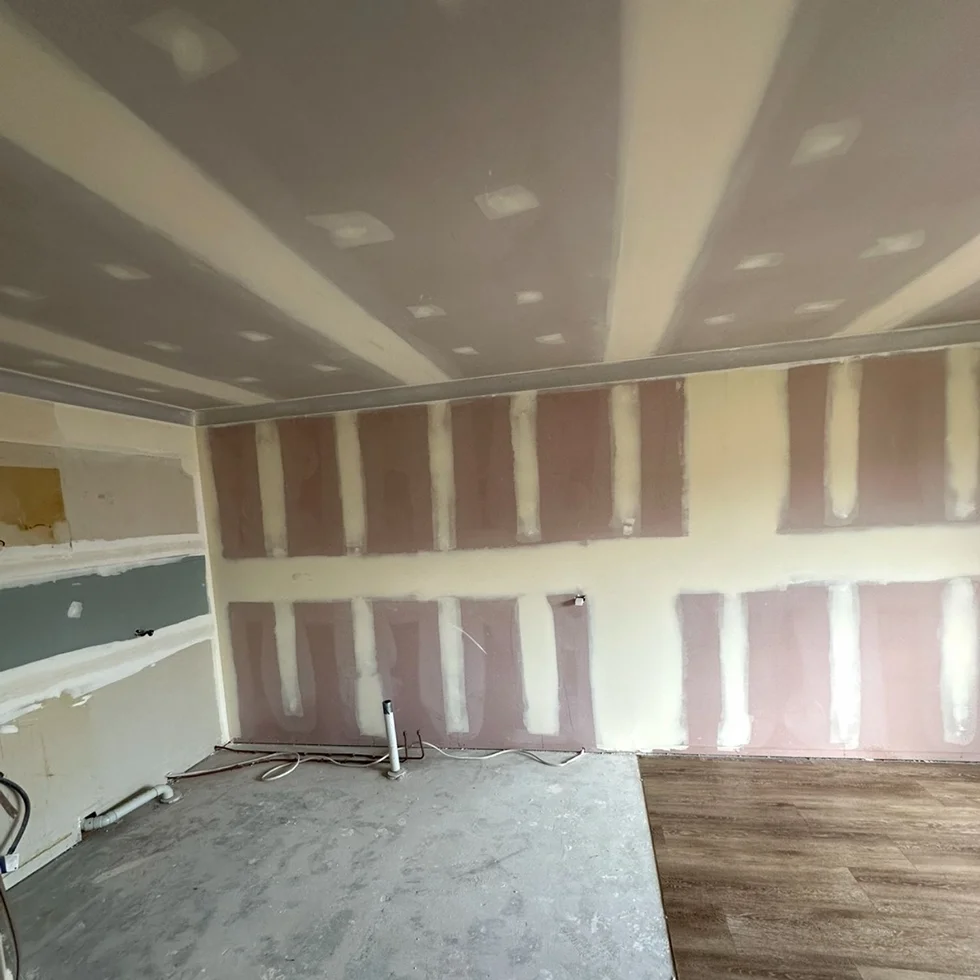 Dining room ceiling with plaster repair patches across surface